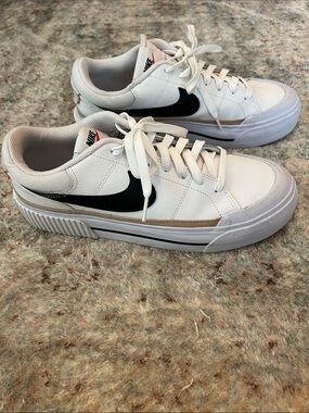Nike White Sneakers with Black Swoosh and Tan Accent